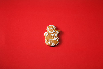 Gingerbread snowman on a red background. The basis for the design of the poster or postcards. It is possible to cut at a square, horizontal or vertical format.