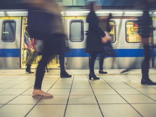People getting off the subway train. Motion blur. City life. Retro effect.