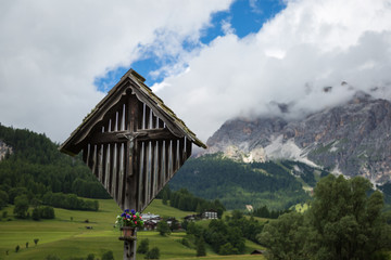 Wooden Christian Cross and Italian Dolomites Alps in Background