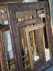 Fototapeta na wymiar Stack of Golden Wooden Vintage Frames, Indoors