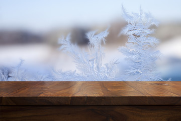 Empty top wooden table and frozen blurred background