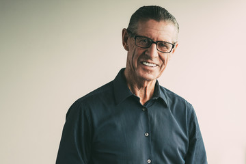 Happy Senior Man Wearing Glasses Smiling at Camera