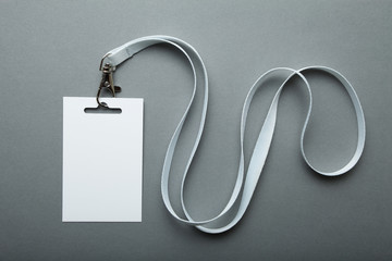 Blank badge mockup isolated on grey. Plain empty name tag mock up hanging on neck with string.