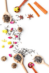 Dried tea leaves near supplements like flowers and spices on white background top view pattern copyspace