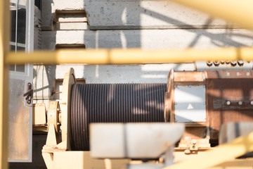 large yellow metal coil with electric cable on a special crane outdoor closeup