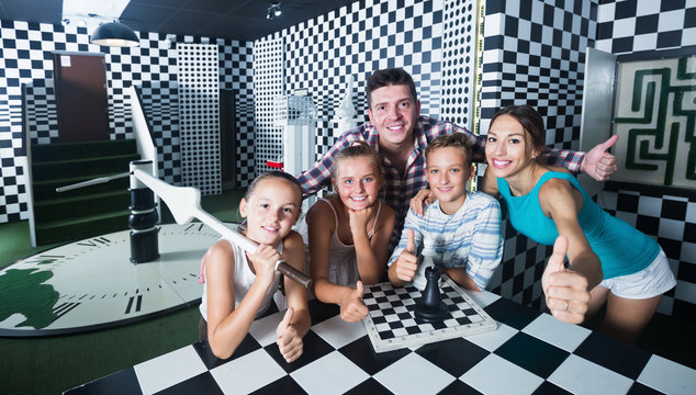 Family with children are visiting stylized chess room