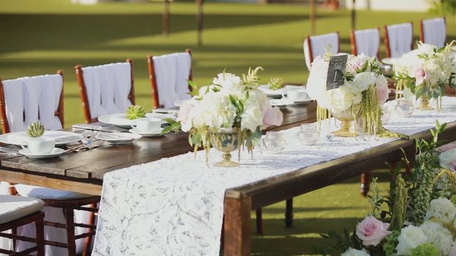 attractive picture of wonderful decorated wedding table with fresh flowers outdoors of resort hyatt,maui,hawaii