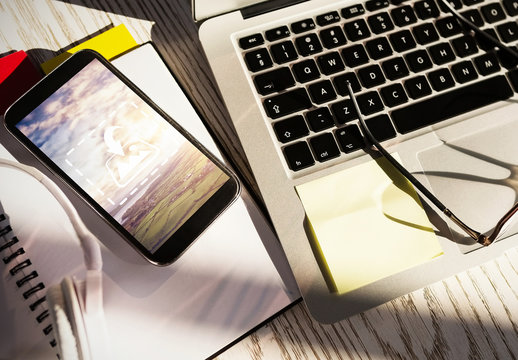 Smartphone Mockup on a Desk with Laptop