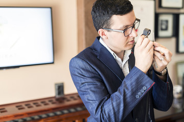 Jeweler examining diamond through loupe