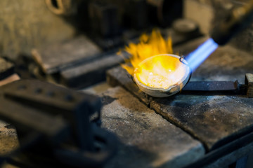 Jeweler welding gold