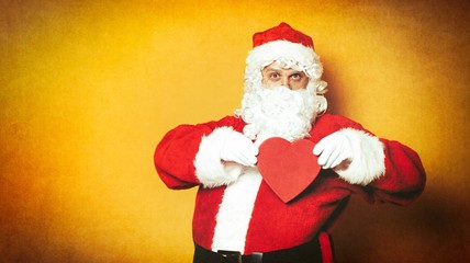 Fototapeta na wymiar Santa Claus holding heart shape gift