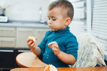 baby in the kitchen eagerly eating the delicious cream horns, vanilla cream