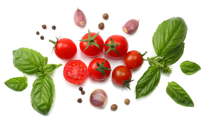 mix of slice of tomato, basil leaf, garlic and spices isolated on white background. top view