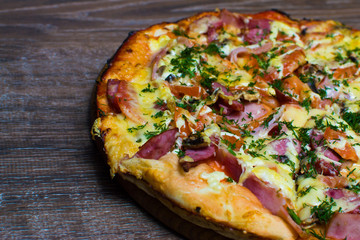 pizza with ham and cheese on a board
