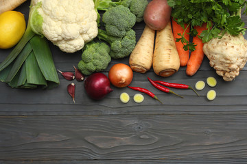 Fresh vegetables on dark wooden background. Mockup for menu or recipe. Top view with copy space