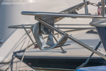 Recreational boats in the background, Embedded anchor in the bug gangway