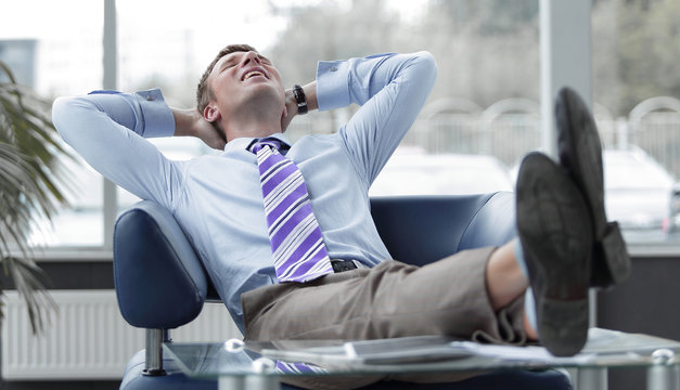 Young Businessman Leaning Back In His Chair