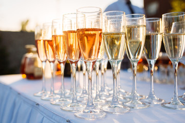 A lot of wine glasses with a cool delicious champagne or white wine at the event catering
