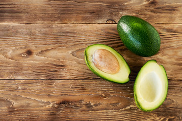 Avocado on a wooden background with copy space. Healthy food concept