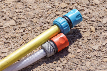 hose pipe and coupling on ground - selective focus on the front