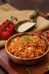 Home cooked Spanish rice served in a wooden bowl, selective focus