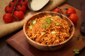 Home cooked Spanish rice served in a wooden bowl, selective focus