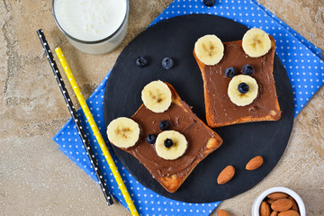 Breakfast for children - toast with chocolate paste, banana and berries. Good morning!