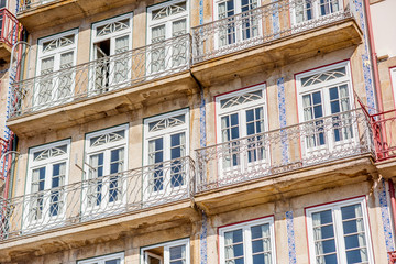 Street view on the beautiful old buildings with portuguese tiles on the facades in Porto city, Portugal