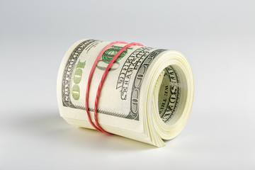 The pack of dollars is twisted into a roll