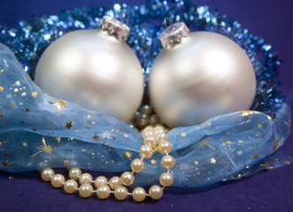 beautiful silvery New Year's ball, brilliant tinsel and a pearl beads on a blue background - New Year's composition, a card..