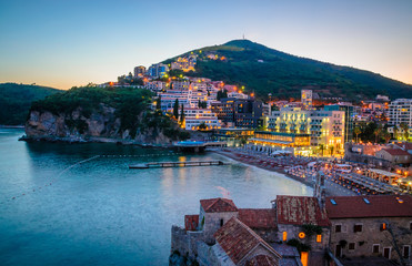 Fototapeta premium Aerial view on illuminated coastline and old town at night in Budva, Montenegro