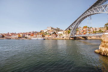 Fototapeta na wymiar Landscape view on the Douro river with famous Luis Bridge in Porto city, Portugal