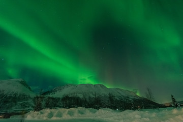 Northern lights over snowy mountain in winter ,Tromso,Norway