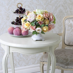 the Bouquet of artificial roses on a table in a vase, as an interior decoration