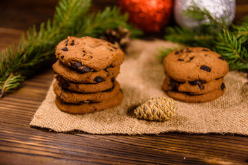Chocolate chip cookies and christmas decorations on a wooden table