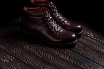 men's boots shoes on a wooden background.