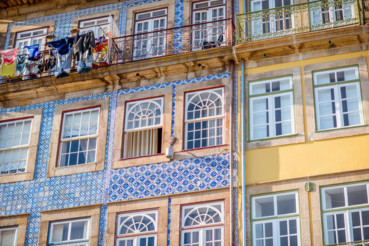 Street view on the beautiful old buildings with portuguese tiles on the facades in Porto city, Portugal