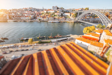 Landscape view the beautiful old town with famous iron bridge above the Douro river during the sunset in Porto city, Portugal