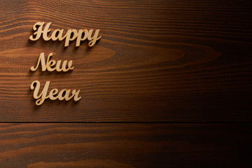 Happy New Year!/Happy New Year! - A phrase with wooden letters on a wooden backg
