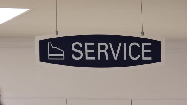 Motion of service sign hanging up the roof inside sears store with 4k resolution