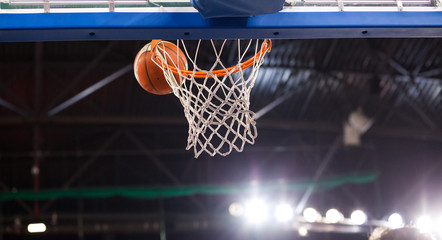 Fototapeta premium scoring during a basketball game - ball in hoop