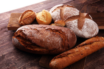 bakery concept with bread and bread rolls on wooden background.
