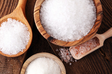 differnt kind of salt in wooden bowl and spoon.