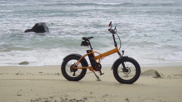 Battery Powered Bicycle Parked on Sandy, Tropical Beach