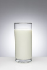 Glass of milk with a light gradient on the background
