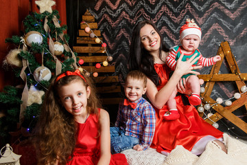 Mother with kids in a Christmas photo session