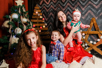 Fototapeta premium Mother with kids in a Christmas photo session