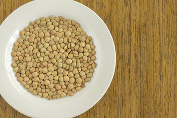 White dish with raw lentil
