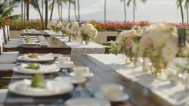 serving exquisite wedding table with beautiful flowers outdoors on resort hyatt,maui,hawaii