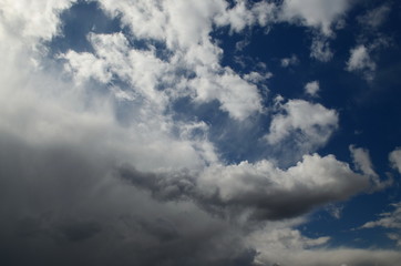white and a dark clouds on a blue sky, bad weather, background